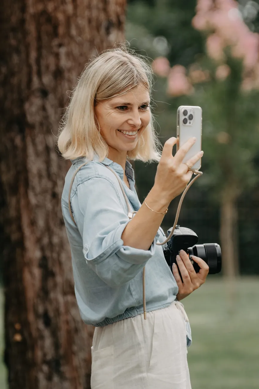 Lisa filmt mit dem Handy, die Kamera in der anderen Hand